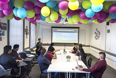 Youth at Digital NEST in a workshop with balloons floating above them