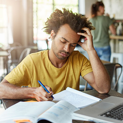 Young man studying with computer