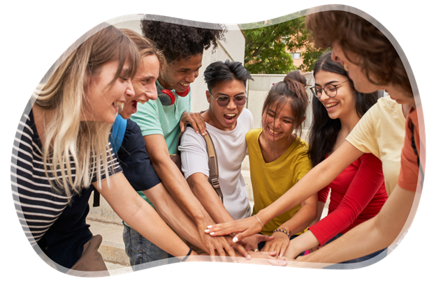 group of teenagers putting their hands together to cheer