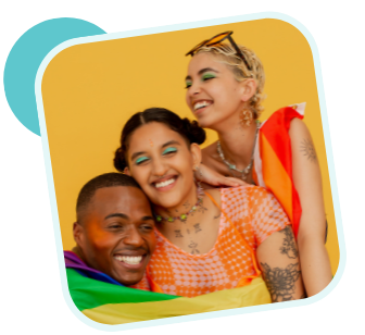 Photo of three LGBTQ teens smiling and hugging while wrapped in a pride flag